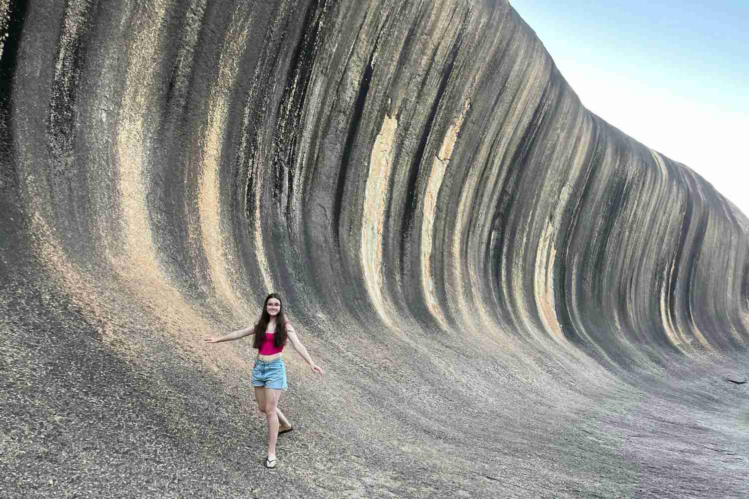 Sunshine appears to be surfing the Wave Rock, a giant rock feature that looks like a giant wave